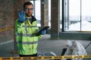 Stop gesture, by a hand, no trespassing. Detectives are collecting evidence in a crime scene near dead body photo