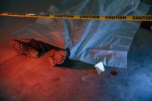 Dead body ,of a man is on the ground, covered in white cloth. Conception of murder, homicide photo