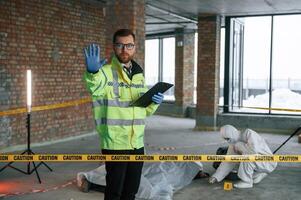 Stop gesture by a ,hand, no trespassing. Detectives are collecting evidence in a crime scene near dead body photo