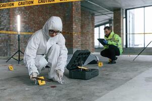 At ,daytime. Detectives are collecting evidence in a crime scene near dead body photo