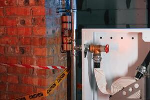 Bomb is planted, near fire hose. Explosive is indoors. Police investigation. Conception of terror photo