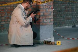 Detective i,n coat is on the crime scene with explosive bomb photo