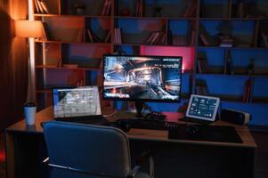 Computer with online ,first person shooter game launched. In dark room with neon lighting photo