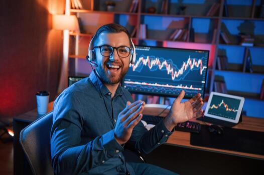 Applauds,, conception of success. Stock trader is working by pc indoors. Conception of exchange and money photo