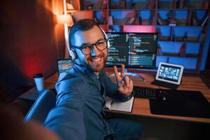 Professional, programmer, is, working indoors. Neon lighting photo
