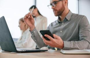 Side view of man that is sitting. .Successful team are working together in the office. Conception of business photo