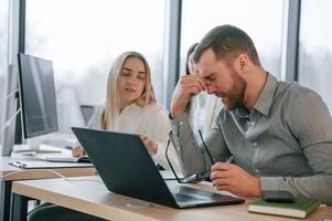 Man, is feelingm bad about failure. Team are working together in the office. Conception of business photo