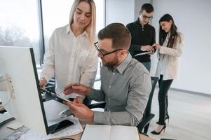 Having, conversation about ideas. Successful team are working together in the office. Conception of business photo