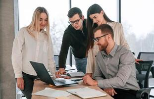 Discussing, the project ideas. Successful team are working together in the office. Conception of business photo