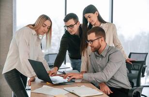 Discussing the, project ideas. Successful team are working together in the office. Conception of business photo
