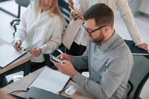 Having, conversation, about ideas. Successful team are working together in the office. Conception of business photo