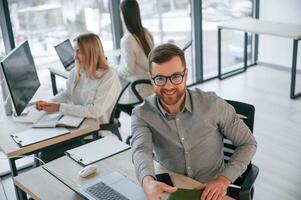 Front view ,of man. Successful team are working together in the office. Conception of business photo