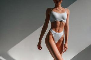 Close up view of the body... Young caucasian woman is indoors in the studio photo