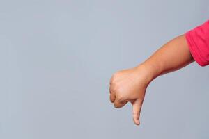 Thumbs down hand gesture expressing disapproval, rejection, and negativity photo