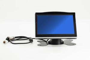 Dashboard monitor with stand and cable setup for enhanced visual display in vehicle photo