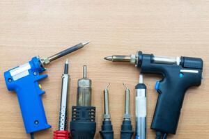Soldering tools arranged neatly on a wooden surface for electronics projects photo