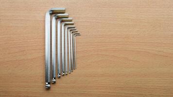 Hex wrench set arranged neatly on a wooden surface showcasing tools for precision tasks photo