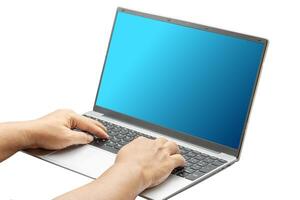 Person using a laptop with both hands resting on the keyboard photo