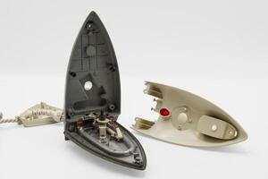 Disassembly process of an electric iron showing internal components and structure photo