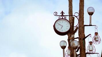 Classic Roman numeral clock against a serene sky background, symbolizing time. photo