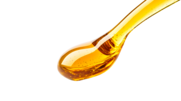 Golden syrup drop close-up with air bubbles, cut out transparent png
