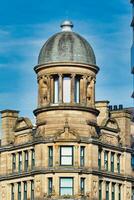 Sandstone Building with Dome Roof against Blue Sky in Manchester, UK. photo