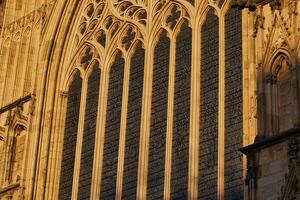 Gothic Window Detail with Stained Glass and Stone Tracery in York, UK. photo