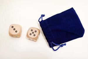 Dice cubes resting on a white canvas. Assorted dimensions. photo