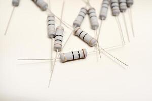 Ceramic electrical resistors arranged on a plain white base. Electronic modules for circuitry systems. photo