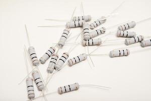 Ceramic-based resistors positioned on a pristine white backdrop. Circuit elements for electronic gadgets. photo