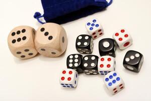 Ivory-backdropped dice. Differing from big to small. photo
