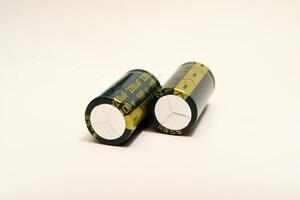 Polarized capacitors displayed against a clean white surface. Essential elements for powering electronic gadgets. photo
