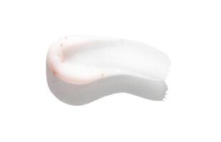 White cream smear on white background with shadow highlighting texture and consistency. photo