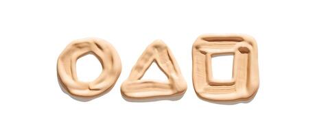 Geometric shapes circle triangle square formed with beige liquid foundation on white background. photo
