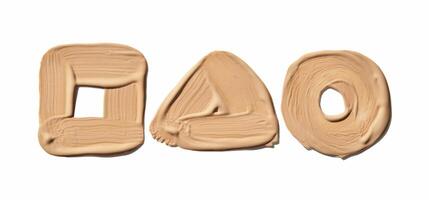 Beige makeup smudges forming square triangle and circle shapes on white background. photo