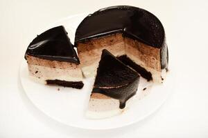 Velvety Coffee Cream Cheesecake. A cake with cheese and chocolate on a plate. photo