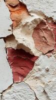 Close up of colorful peeling plaster wall with textured layers and cracks. photo