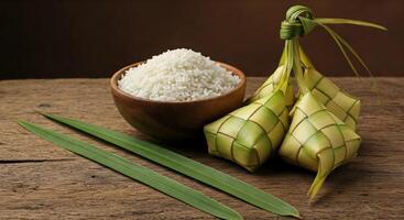 Rice and bamboo leaves on a wooden table photo