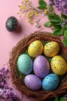Easter eggs in a nest on a pink background photo