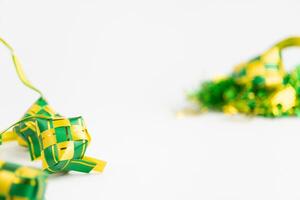 eid al fitr idul fitri ramadan ketupat lebaran empty white background bokeh focus foreground blur shallow depth of field photo