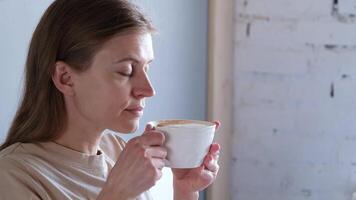 woman waking up and drinking hot coffee sitting in bed , morning routine video