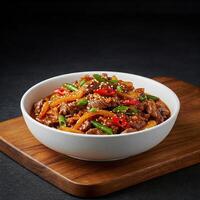 A bowl of stir fry with meat and vegetables photo