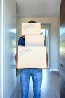A man holding three boxes with the words move and sell on them photo