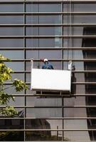A man is cleaning a window on a building photo
