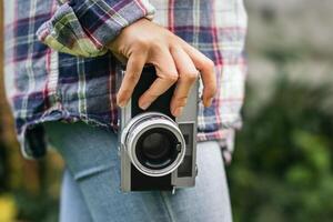 A person holding a camera in their hand photo