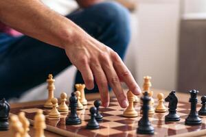 A person is playing chess on a table photo