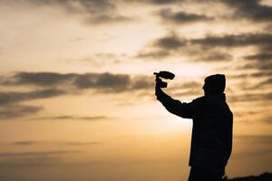 A man holding a camera in the air photo