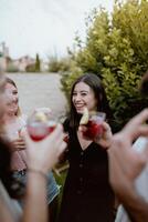 A group of people toasting with drinks photo