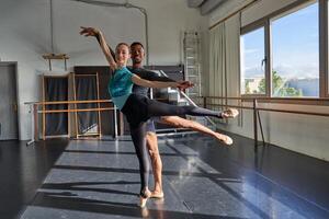 Two dancers in a dance studio with large windows photo