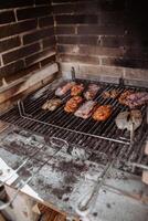A grill with meat and vegetables cooking on it photo